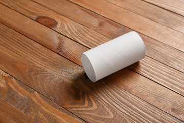 Cardboard tube for toilet paper on wooden background