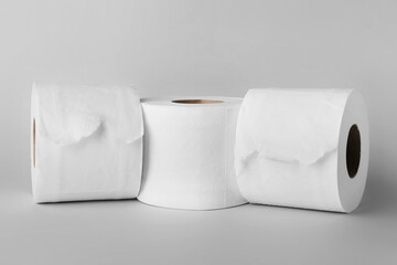 Rolls of toilet paper on grey background
