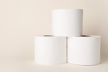 Rolls of toilet paper on color background