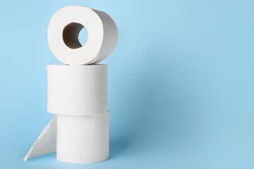 Rolls of toilet paper on color background