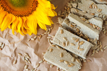Halva cut into pieces with sunflower seeds top view. Country style. Juicy dessert slices with selective focus.