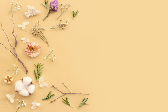 Top view image of flowers composition on pastel yellow background .Flat lay