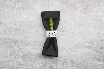 Fabric napkin with ring on grunge background