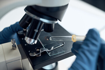 woman in laboratory microscope science research analysis