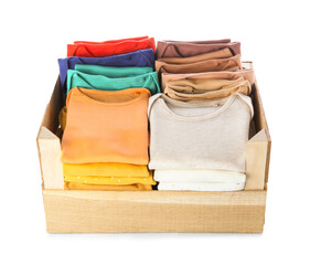 Wooden box with baby clothes on white background