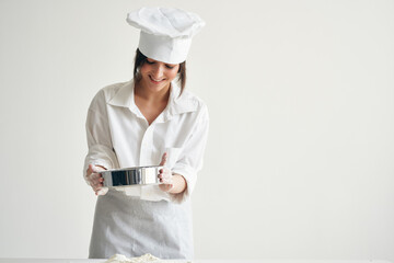 woman in chef's uniform kneading onion dough kitchen bakery cooking pastry