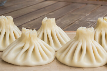 Georgian traditional food khinkali on the plate in restaurant, ready to eat, hot dish.