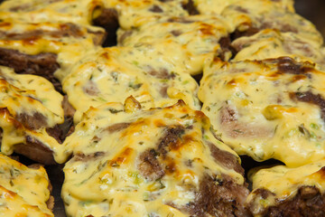 Baked beef fillet in cheese and spices close-up. Beef steaks.