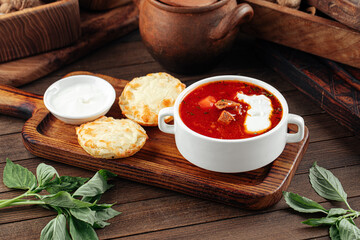 Russian beet root soup borscht with sour cream on the wooden background