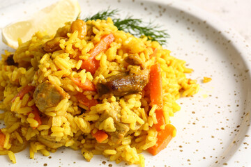 Plate with tasty pilaf on table, closeup