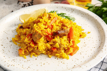Plate with tasty pilaf on table, closeup