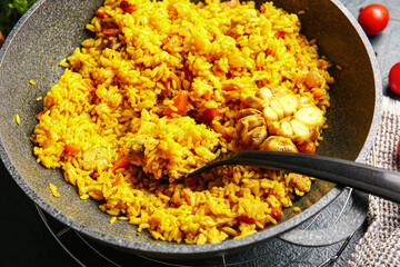 Frying pan with tasty pilaf on table, closeup