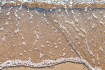Soft wave of the sea on the sandy beach.Soft focus,blurred image.