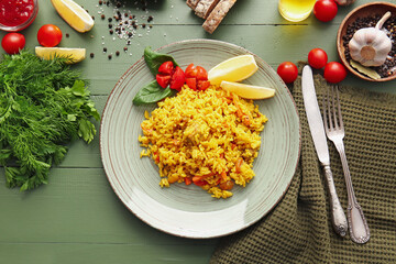 Composition with tasty pilaf on color wooden background