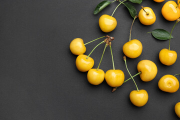 Tasty sweet cherries on dark background