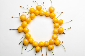 Frame made of tasty sweet cherries on white background