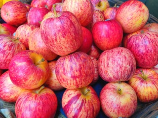 A jute basket full of hybrid apples kept for selling in the market