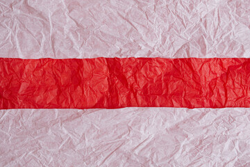 White crumpled paper background. Red paper tape for text.