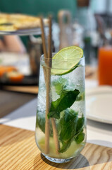 Mojito cocktail with lime and mint in  glass
