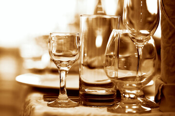 Glass goblets on the restaurant table tinted in brown.