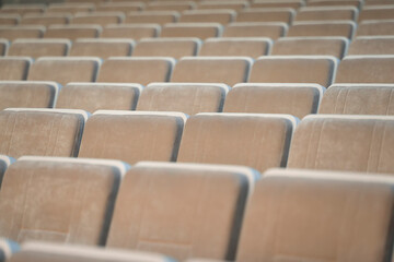 Fototapeta premium A row of empty beige chairs in the auditorium.