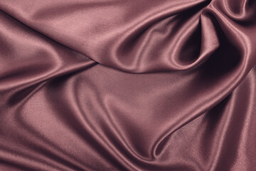 Smooth elegant pink silk or satin luxury cloth texture as abstract background. Luxurious background design