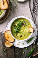 Cream of green peas soup with toasts and sour cream.