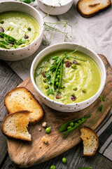 Cream of green peas soup with toasts and sour cream.