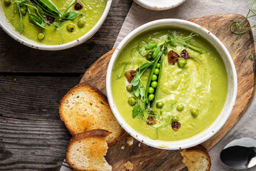 Cream of green peas soup with toasts and sour cream.