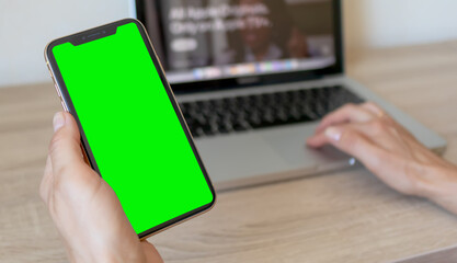 Macbook and mobile phone with green screen