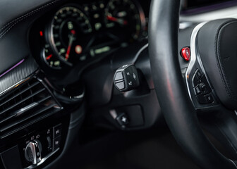 Obraz na płótnie Canvas Modern sports car Interior, travel concept. Car dashboard. Focus on headlight knob in the car