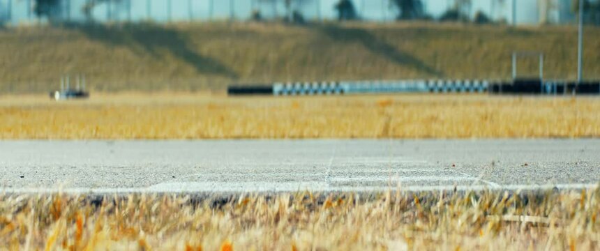 LOW ANGLE Two racing karts passing finish line simultaneously on a race track