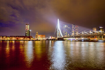 Fototapeta premium Netherlands Travel Concepts. Tranquil Night View of Renowned Erasmusbrug (Swan Bridge) in Rotterdam in Front of Port with Harbour. Shoot Made At Dusk.