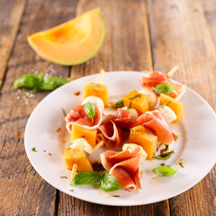 melon salad with mozzarella and prosciutto ham