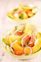 melon slices with avocado, mozzarella and ham