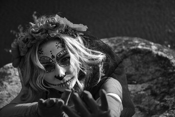 Closeup portrait of Calavera Catrina. Young woman with sugar skull makeup. Dia de los muertos. Day...