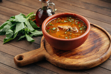 Georgian national kharcho soup with beef and rice on the wooden background