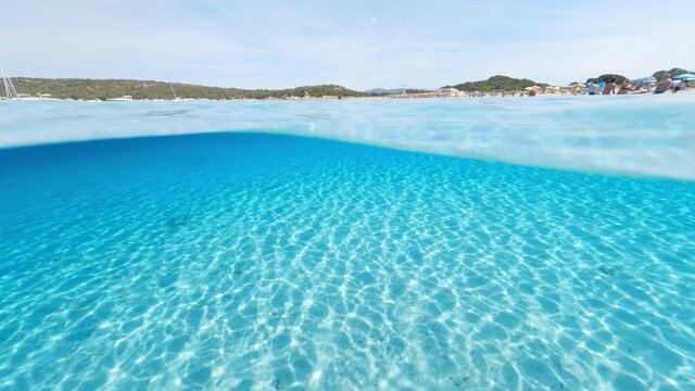 Split-shot, over-under shot. Stunning view of half underwater half sky with a beautiful and turquoise water. Liscia Ruja, Sardinia, Italy.