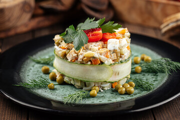 Restaurant garnished russian olivier salad on wooden background