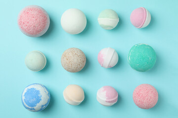 Different bath balls on blue background, top view