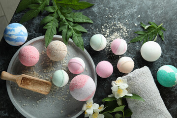 Body care concept with bath balls on black smokey table
