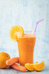 carrot and orange fresh juice on blue table