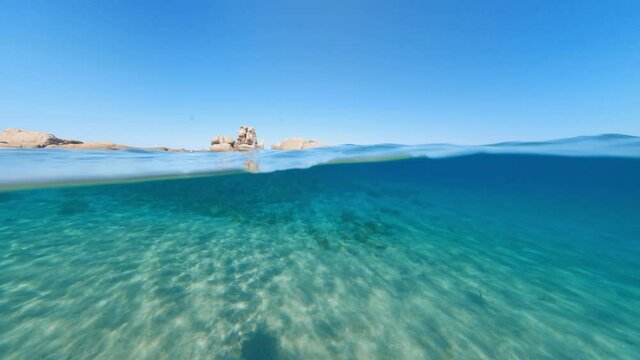 Split-shot, over-under shot. Stunning view of half underwater half sky with a beautiful and turquoise water. Liscia Ruja, Sardinia, Italy.