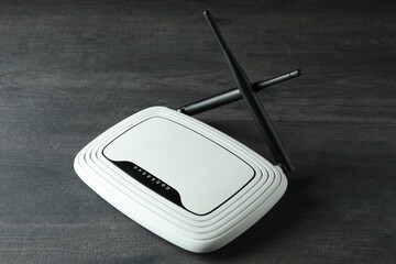Wi-Fi router with external antennas on dark wooden background