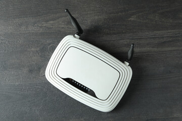 Wi-Fi router with external antennas on dark wooden background
