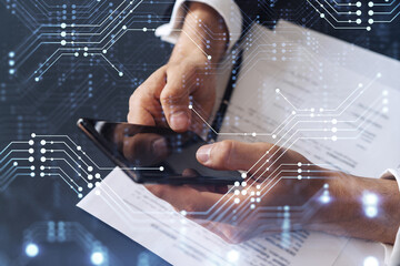 A client in formal wear reading the contract to create a software to present it at start up conference and gain investments for innovative service. Checking details at smartphone. Hologram.