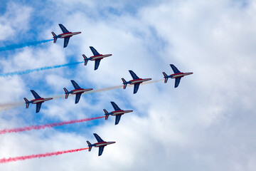 Paris, France - July 14 2021: The French Air Patrol (French: Patrouille de France) performing a demonstration to celebrate the Bastille Day.