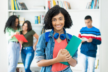 Laughing mexican female student with group of students