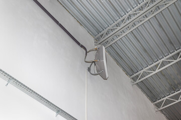 Industrial heater, hanging on the wall of the hall, used for air heating and for cooling with cold...