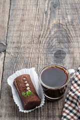 traditional Russian chocolate biscuit cake with cup of coffee on wooden background